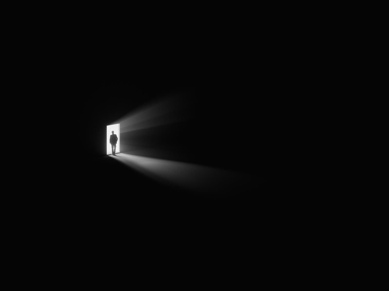 A lit doorway in a dark wall